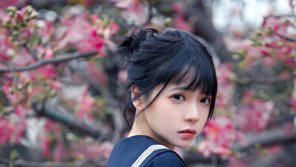 Anime Girl in Sailor Uniform with Pink Cherry Blossom Background 4K Wallpaper