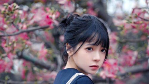 Anime Girl in Sailor Uniform with Pink Cherry Blossom Background 4K Wallpaper