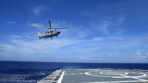 Military Helicopter Hovering Above Naval Ship Flight Deck 4K Wallpaper