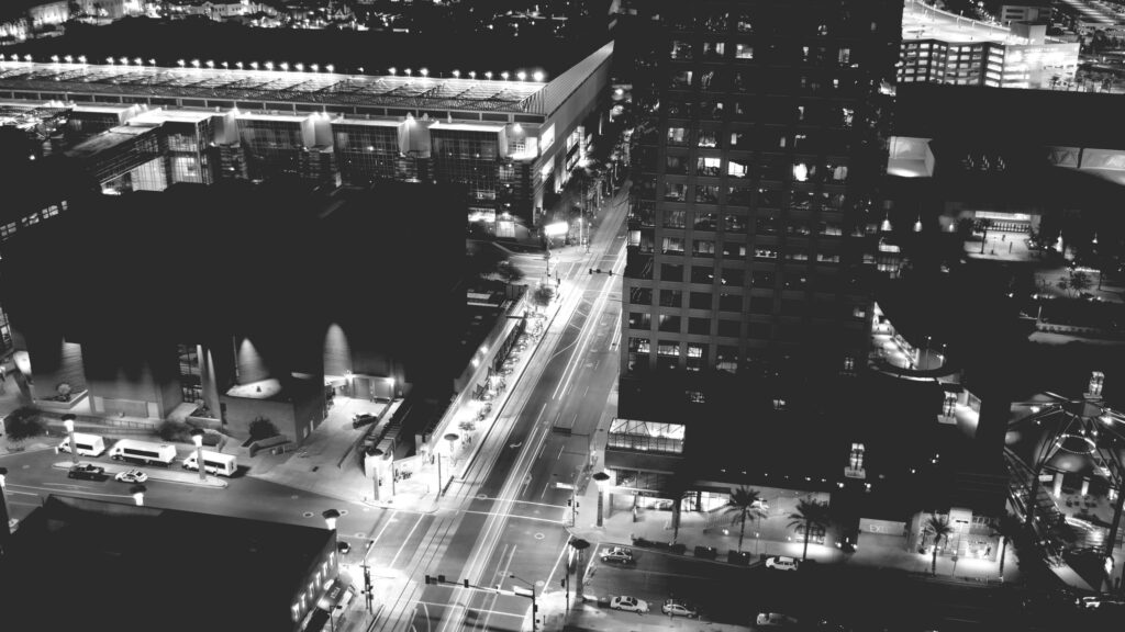 Stunning Aerial Night View of Modern City Street and Skyscrapers 4K Wallpaper
