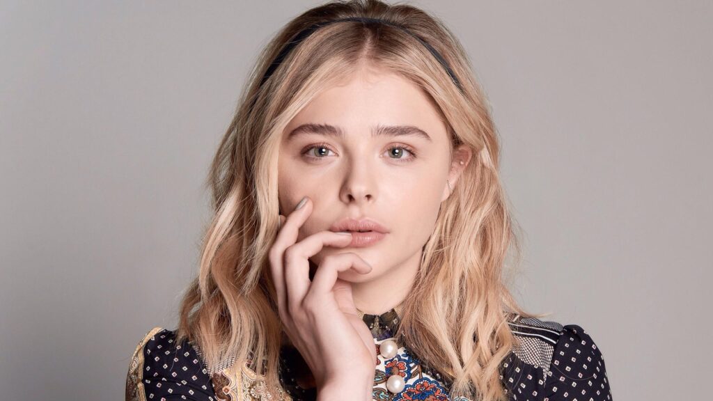 Chloë Grace Moretz Blonde Portrait with Intricate Patterned Blouse 4K Desktop Wallpaper