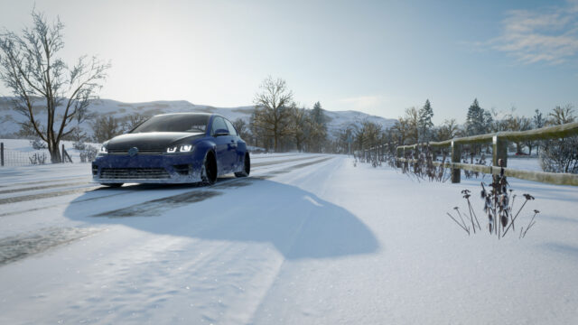 Blue Volkswagen Golf R Driving Through Snowy Landscape PC Wallpaper