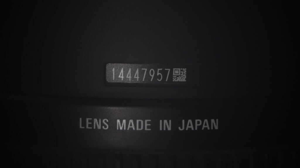 Macro Close Up of Camera Lens Serial Number and Japan Manufacturing Mark 4K Wallpaper