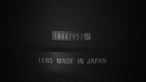 Macro Close Up of Camera Lens Serial Number and Japan Manufacturing Mark 4K Wallpaper