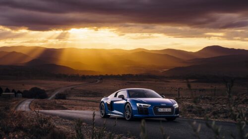 Blue Audi R8 Supercar on Scenic Mountain Road at Sunset 4K Wallpaper