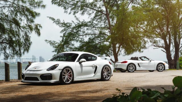 White Porsche Cayman GT4 and Boxster Convertible Parked by the Waterfront 4K Wallpaper