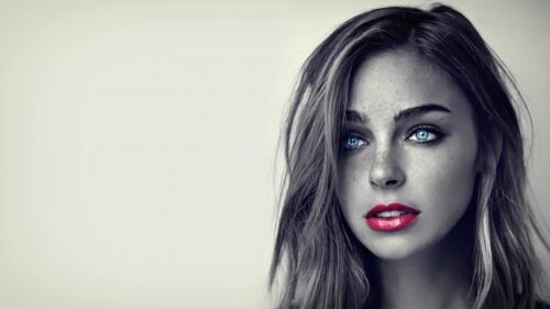 Stunning Portrait of a Woman with Piercing Blue Eyes and Vibrant Red Lips 4K Desktop Wallpaper