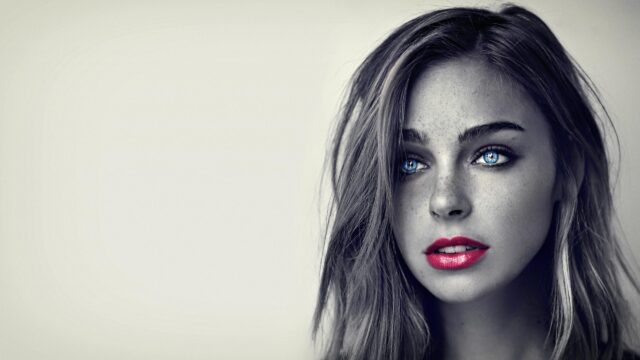Stunning Portrait of a Woman with Piercing Blue Eyes and Vibrant Red Lips 4K Desktop Wallpaper