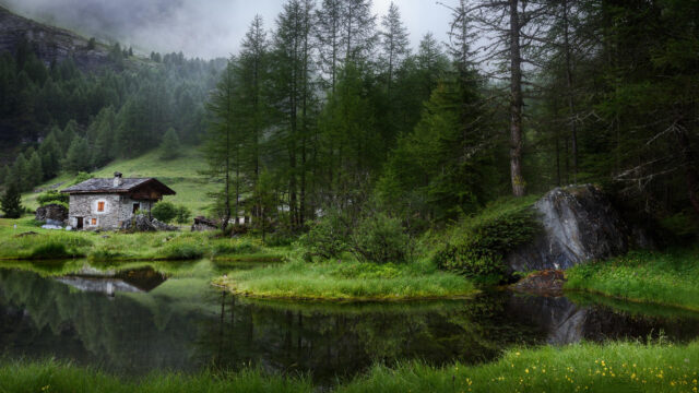 Rustic Stone Cabin by a Misty Alpine Pond 4K Wallpaper