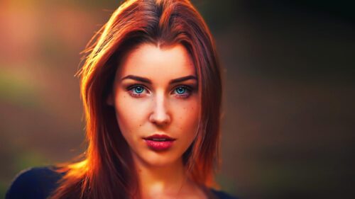 Stunning Portrait of a Woman with Piercing Blue Eyes Desktop Wallpaper