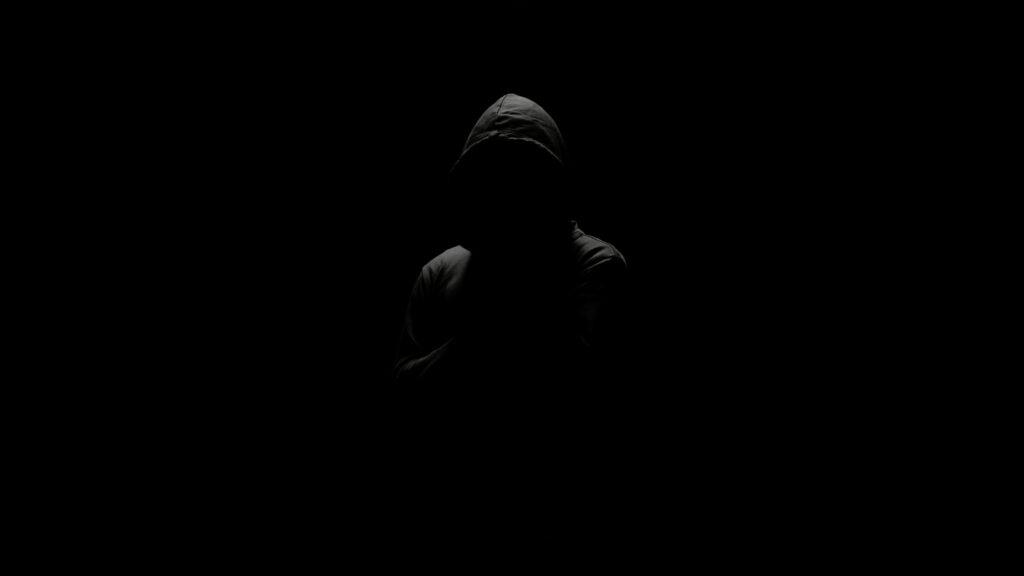 Mysterious Cloaked Figure in Dark Silhouette 4K Desktop Wallpaper