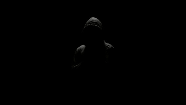 Mysterious Cloaked Figure in Dark Silhouette 4K Desktop Wallpaper