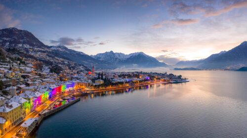 Stunning Snowy Italian Lakeside Village with Colorful Festive Lights 4K Wallpaper