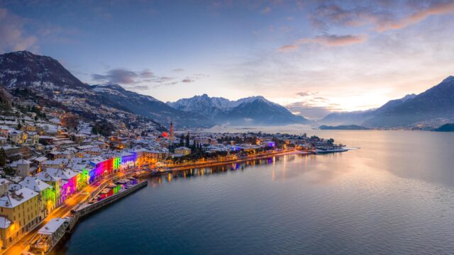 Stunning Snowy Italian Lakeside Village with Colorful Festive Lights 4K Wallpaper