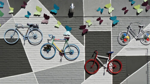 Vibrant Bicycles and Colorful Butterflies Mural Urban Art Desktop Wallpaper