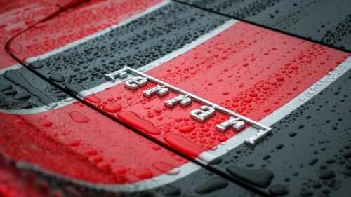 Ferrari Emblem Close-Up with Raindrops on Racing Livery Desktop Wallpaper
