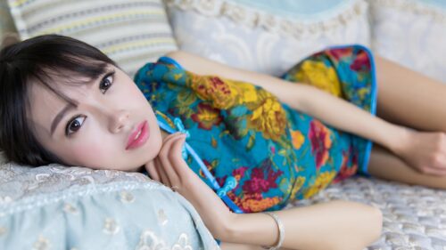Beautiful Young Woman in Floral Cheongsam Lying Down 4K Wallpaper