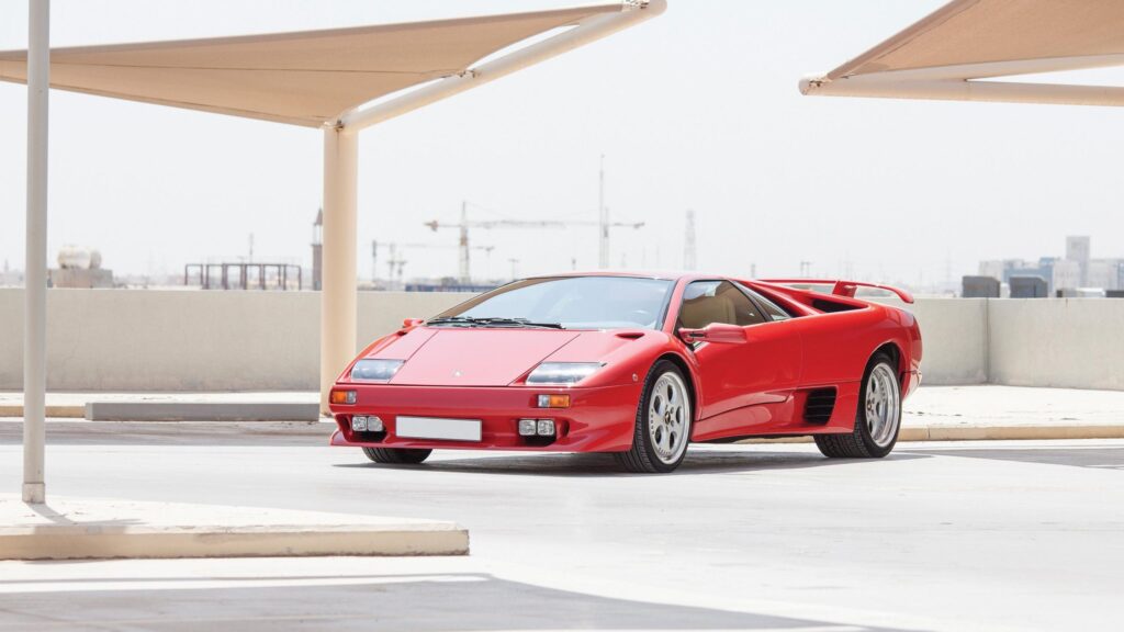 Stunning Red Lamborghini Diablo Sports Car in an Open Parking Lot PC Wallpaper