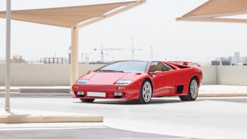 Stunning Red Lamborghini Diablo Sports Car in an Open Parking Lot PC Wallpaper