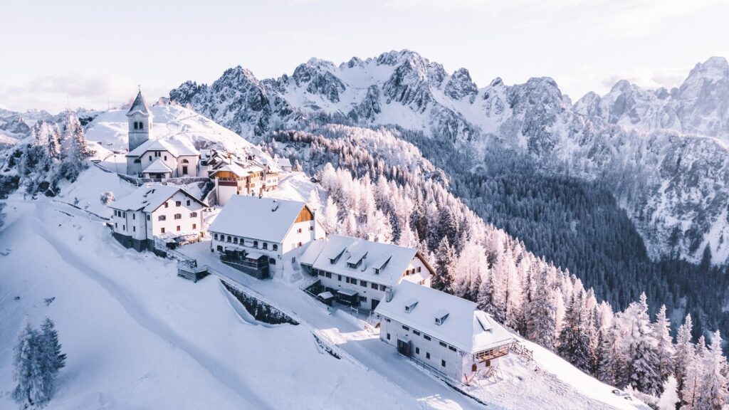 Stunning Snowy Mountain Village Landscape with Church 4K Wallpaper