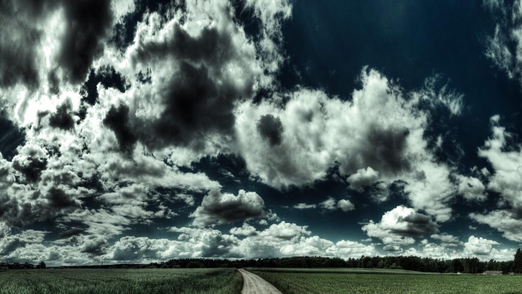 Stunning Countryside Road Under Dramatic Storm Clouds 4K Desktop Wallpaper