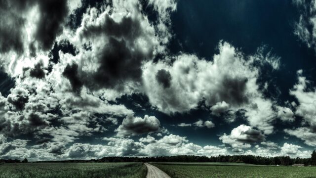 Stunning Countryside Road Under Dramatic Storm Clouds 4K Desktop Wallpaper