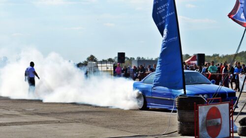 Blue Drift Car Performing Tire Burnout at Racetrack 4K Wallpaper