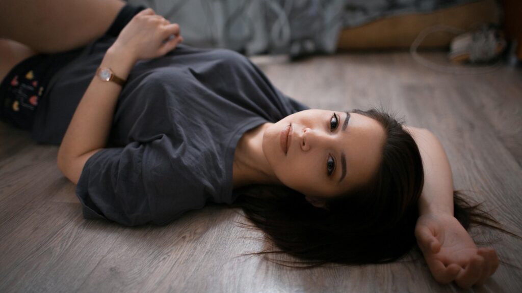 Beautiful Young Woman Resting on Wooden Floor 4K Desktop Wallpaper