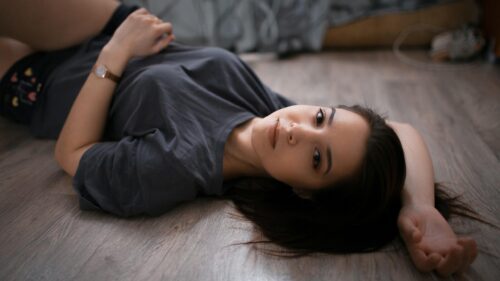 Beautiful Young Woman Resting on Wooden Floor 4K Desktop Wallpaper