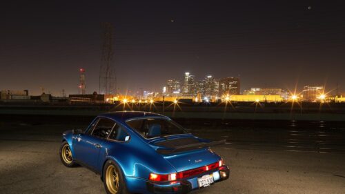 Stunning Blue Porsche 911 Turbo at Night with City Skyline Desktop Wallpaper