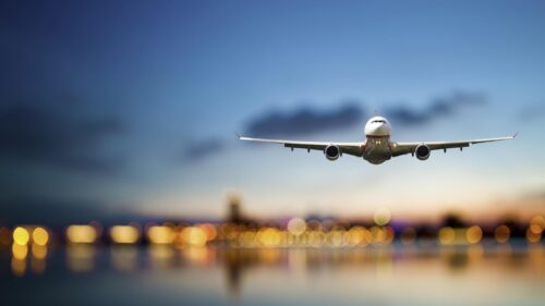 Commercial Jet Airplane Approaching Landing at Sunset 4K Desktop Wallpaper
