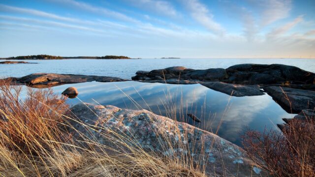 Serene Baltic Sea Rocky Coastline Reflection 4K Wallpaper