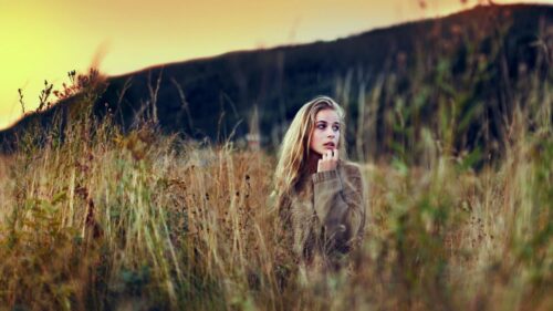 Stunning Blonde Woman in Golden Autumn Grass Field 4K Wallpaper