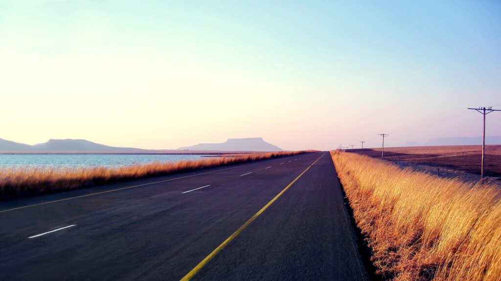 Stunning Open Road Along a Calm Lake Landscape Desktop Wallpaper