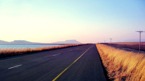 Stunning Open Road Along a Calm Lake Landscape Desktop Wallpaper