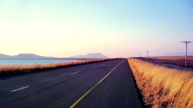 Stunning Open Road Along a Calm Lake Landscape Desktop Wallpaper