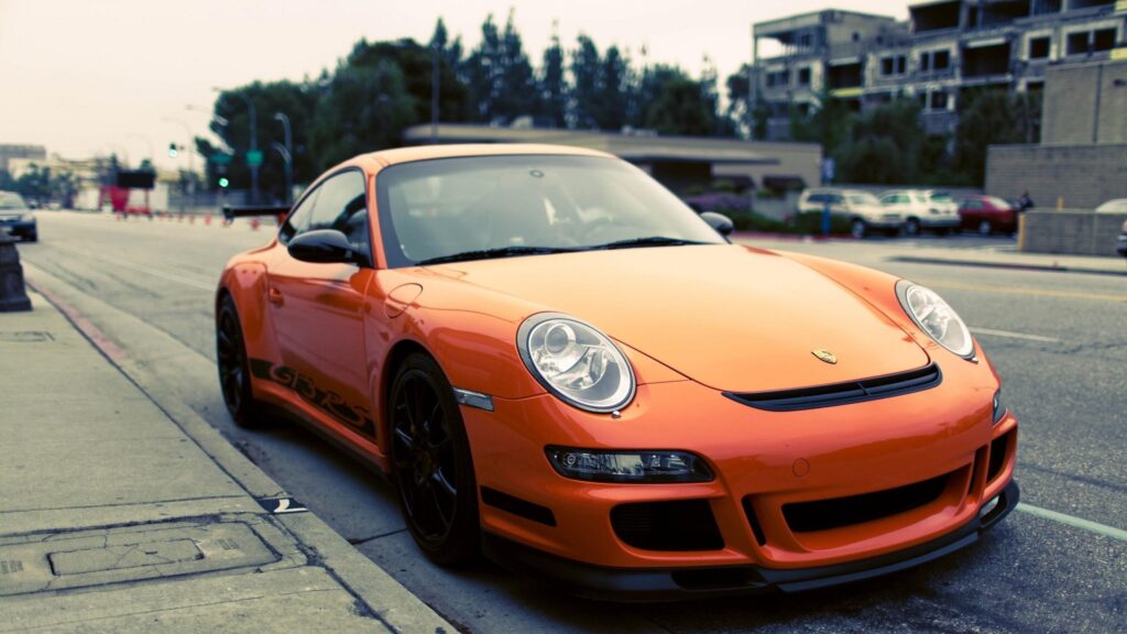 Bright Orange Porsche 911 GT3 RS Parked on City Street Desktop Wallpaper