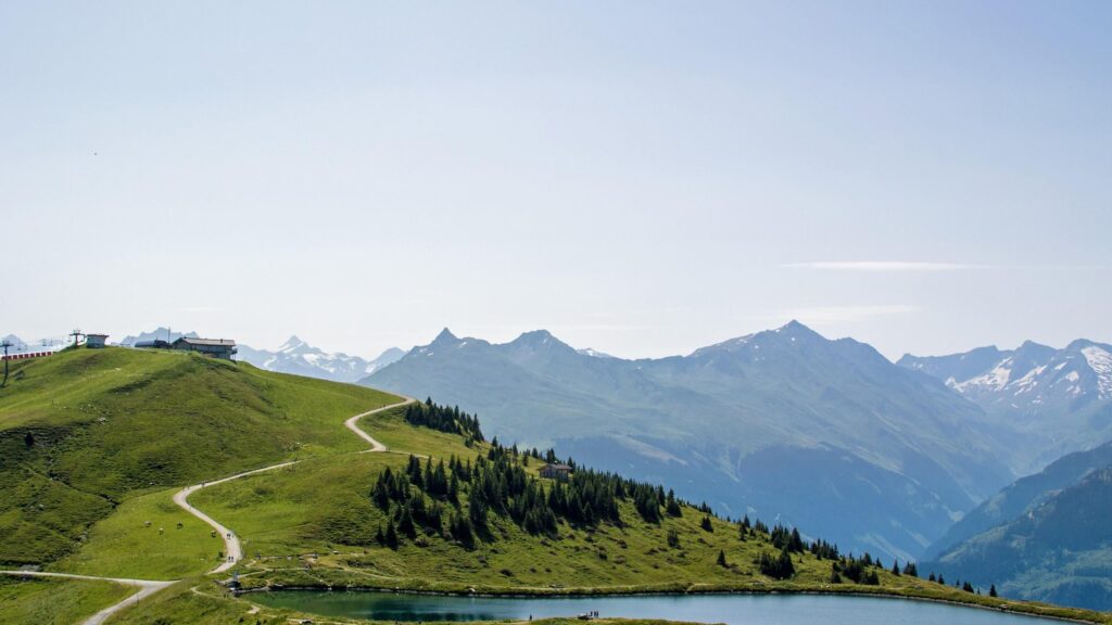 Serene Alpine Mountain Landscape with Winding Trail and Crystal Lake 4K Wallpaper