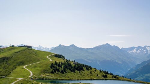 Serene Alpine Mountain Landscape with Winding Trail and Crystal Lake 4K Wallpaper