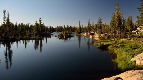 Serene Mountain Lake and Evergreen Forest Reflections 4K Desktop Wallpaper