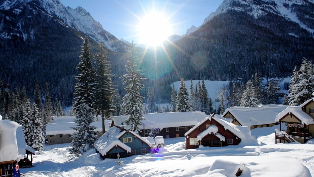 Snow Covered Cabin Village in Snowy Mountain Valley Desktop Wallpaper