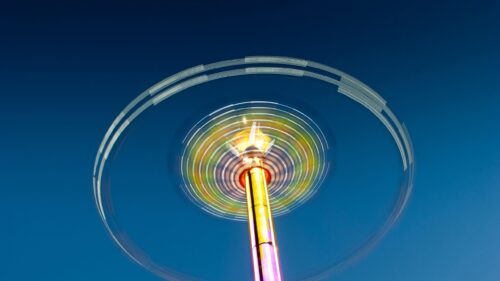 Abstract Motion Blur of a Fairground Swing Ride Against Deep Blue Sky Desktop Wallpaper