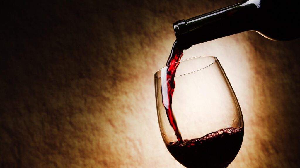 Elegant Red Wine Pouring into a Glass 4K Desktop Wallpaper