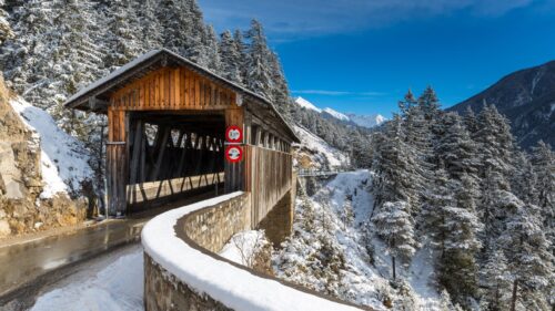 Snowy Covered Wooden Bridge in Alpine Winter Landscape 4K Wallpaper