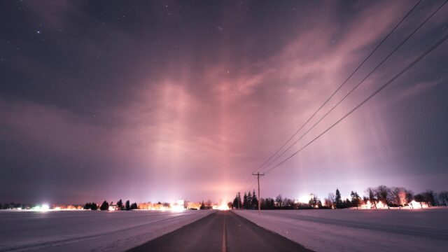 Stunning Light Pillars Over Winter Landscape Night Sky 4K Desktop Wallpaper