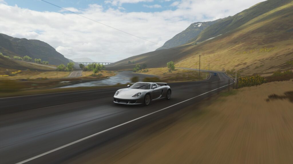 Porsche Carrera GT Driving Through Scottish Highlands Road Desktop Wallpaper