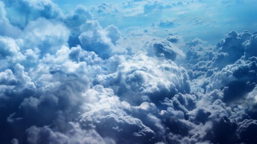Stunning Aerial View of Majestic Fluffy Clouds in Deep Blue Sky 4K Wallpaper