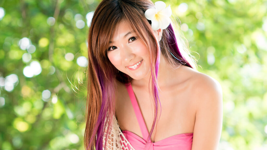 Beautiful Asian Woman with Purple Highlights and Flower Hair Accessory 4K Wallpaper