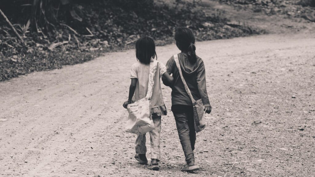 Two Young Friends Walking Down a Dusty Path Black and White Desktop Wallpaper
