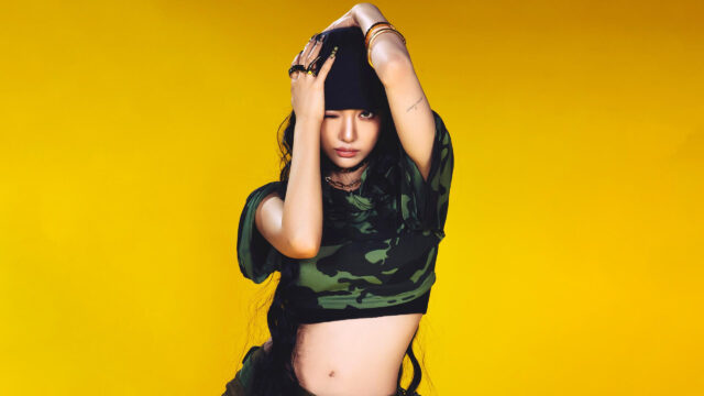 Stunning K-Pop Idol Lisa Blackpink Camouflage Outfit Yellow Background 4K Wallpaper